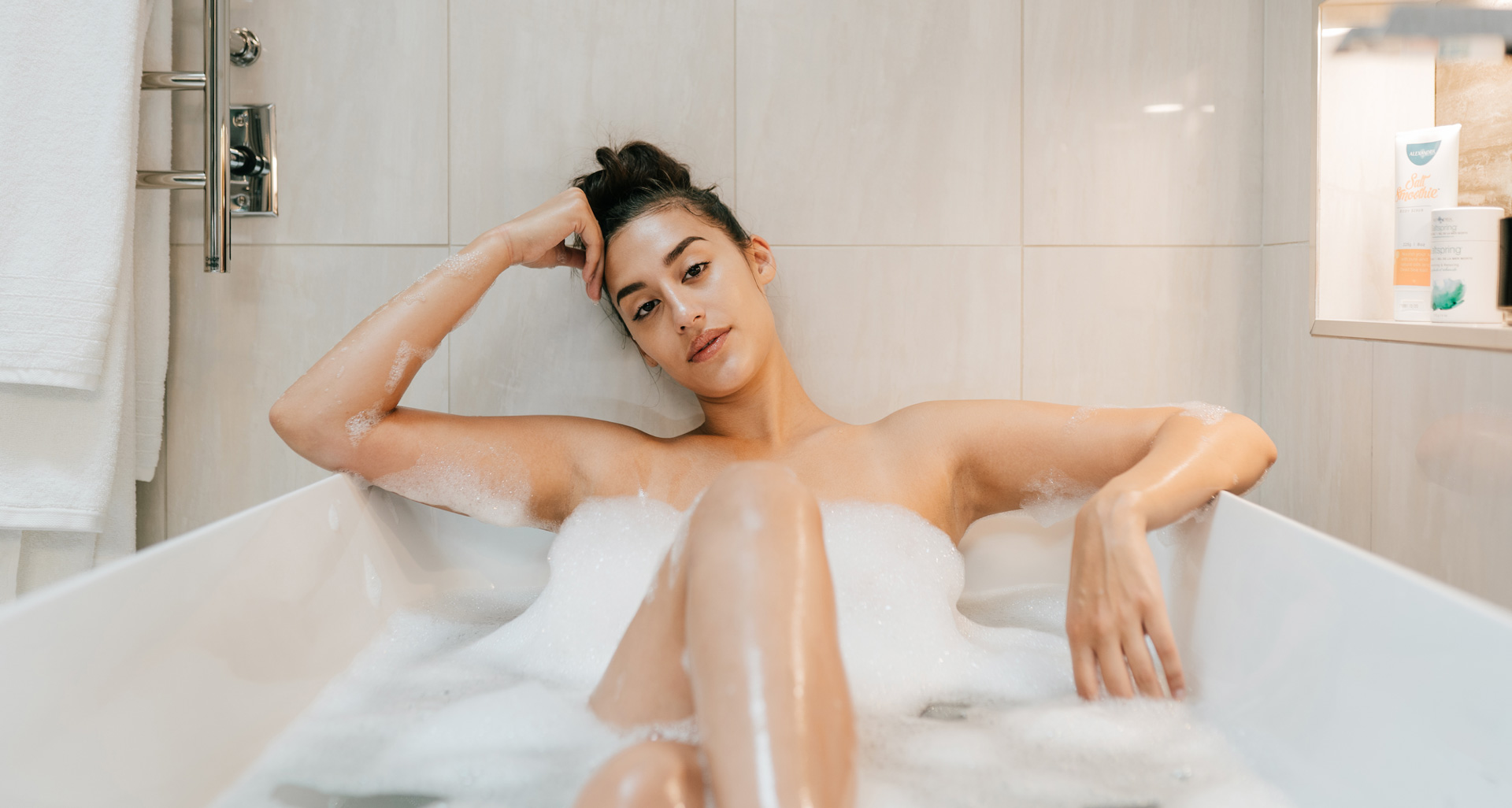 A woman sitting in a bathtub